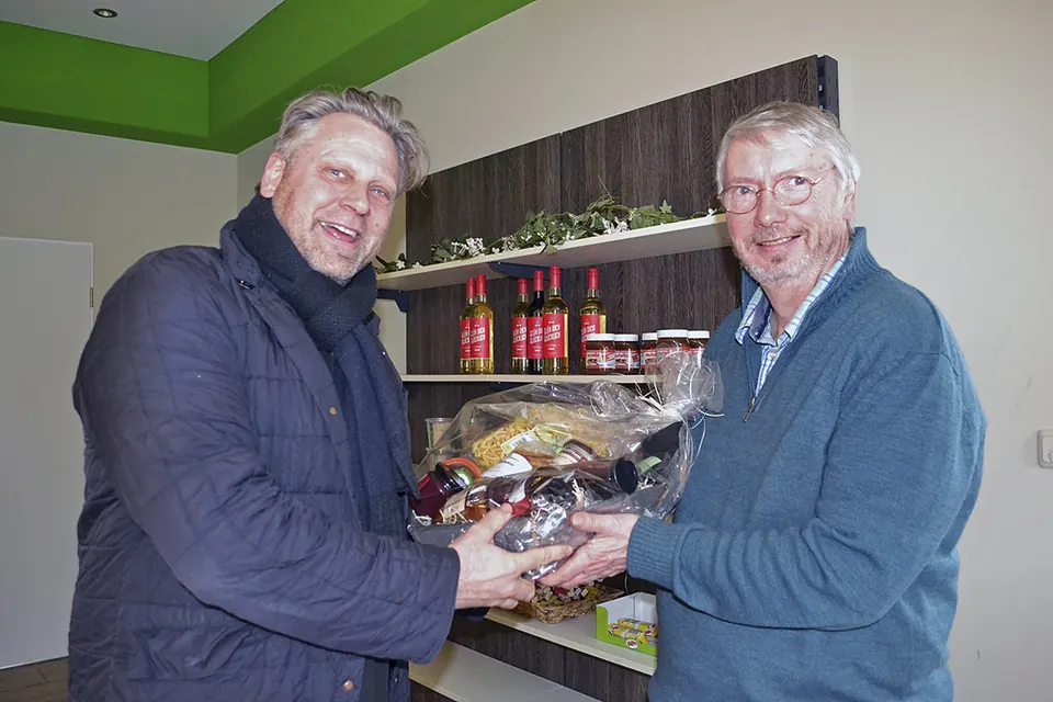Dierk Beneke überreicht Reinhard Riepshoff einen Präsentkorb